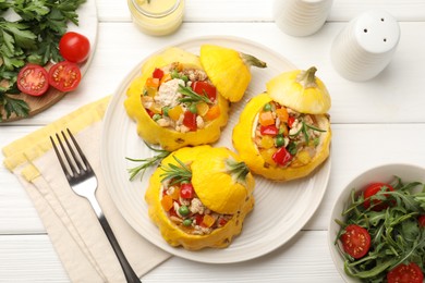 Photo of Tasty stuffed pattypan squashes served on white wooden table, flat lay