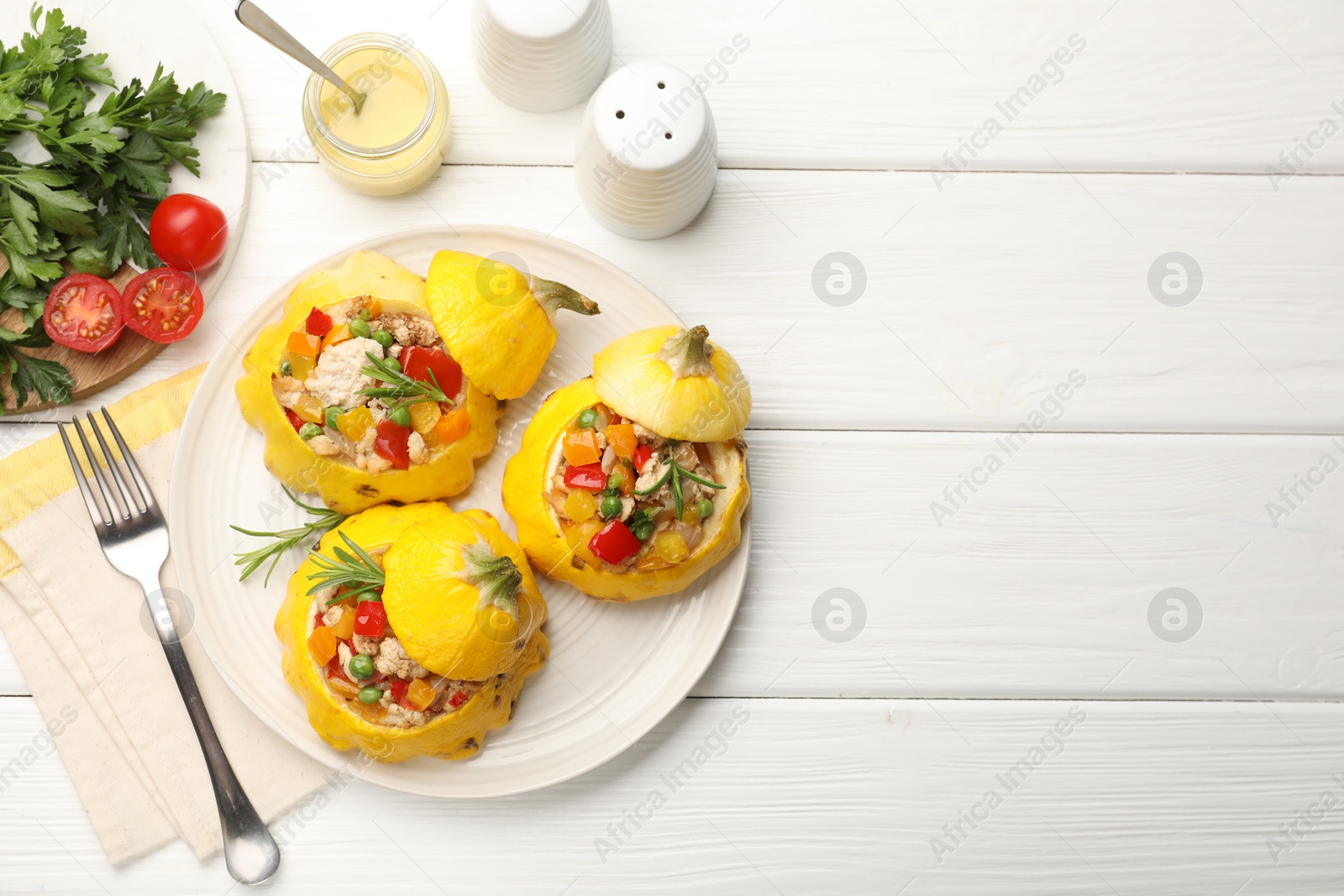 Tasty stuffed pattypan squashes served on white wooden table, flat lay. Space for text Photo of Tasty stuffed pattypan squashes served on white wooden table, flat lay. Space for text