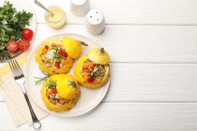 Photo of Tasty stuffed pattypan squashes served on white wooden table, flat lay. Space for text