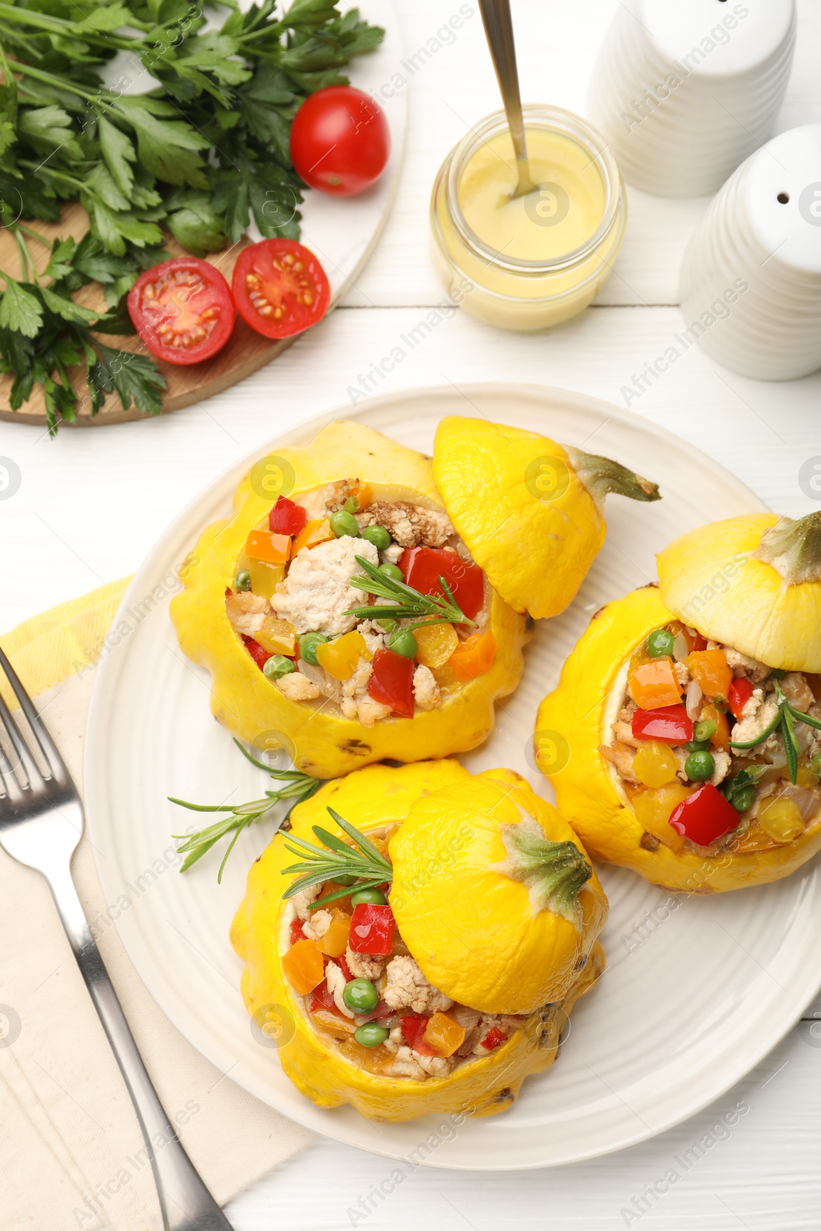 Photo of Tasty stuffed pattypan squashes served on white wooden table, flat lay