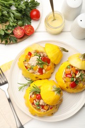 Photo of Tasty stuffed pattypan squashes served on white wooden table, flat lay