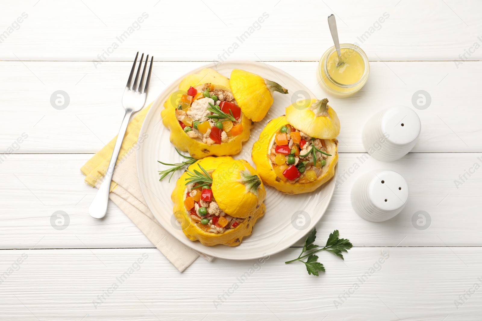 Tasty stuffed pattypan squashes served on white wooden table, flat lay Photo of Tasty stuffed pattypan squashes served on white wooden table, flat lay