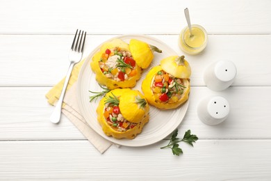 Photo of Tasty stuffed pattypan squashes served on white wooden table, flat lay