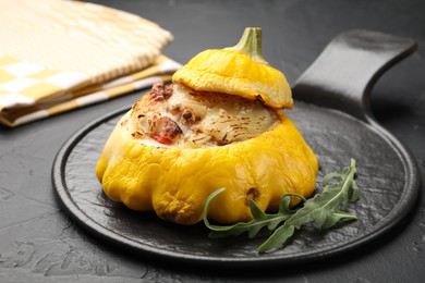 Photo of Tasty stuffed pattypan squash on black table, closeup