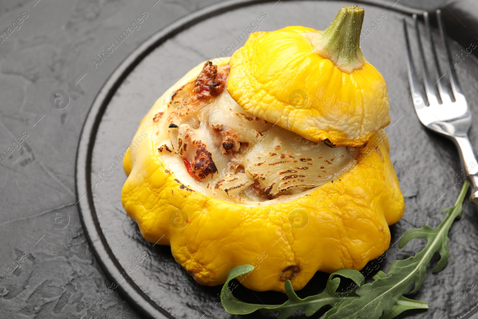 Tasty stuffed pattypan squash served on black table, closeup Photo of Tasty stuffed pattypan squash served on black table, closeup