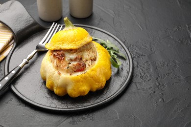 Photo of Tasty stuffed pattypan squash served on black table. Space for text