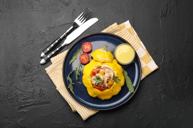 Photo of Tasty stuffed pattypan squash served on black table, flat lay