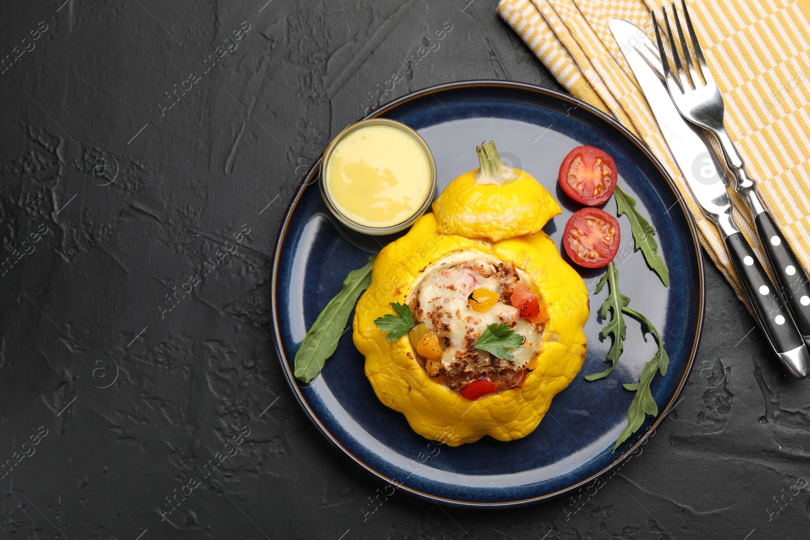 Tasty stuffed pattypan squash served on black table, flat lay. Space for text Photo of Tasty stuffed pattypan squash served on black table, flat lay. Space for text