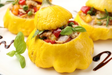 Photo of Tasty stuffed pattypan squashes on plate, closeup