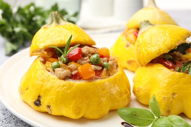 Photo of Tasty stuffed pattypan squashes on grey table, closeup