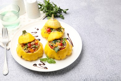 Photo of Tasty stuffed pattypan squashes served on grey table. Space for text