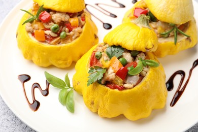 Photo of Tasty stuffed pattypan squashes on grey table, closeup