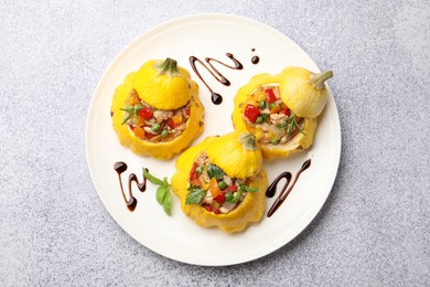 Photo of Tasty stuffed pattypan squashes on grey table, top view