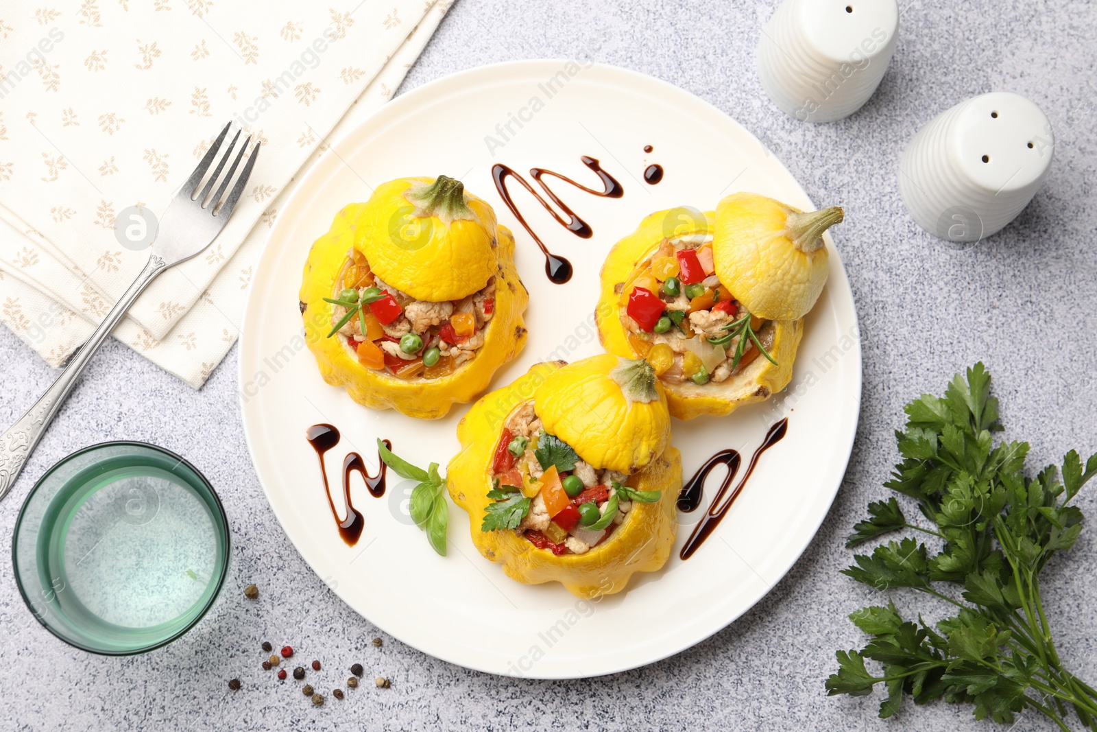 Photo of Tasty stuffed pattypan squashes served on grey table, flat lay