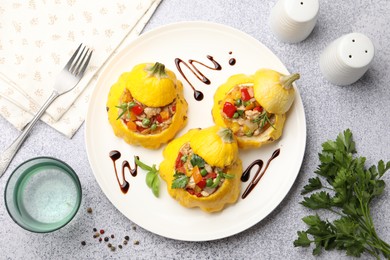 Photo of Tasty stuffed pattypan squashes served on grey table, flat lay