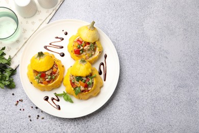 Photo of Tasty stuffed pattypan squashes on grey table, flat lay. Space for text