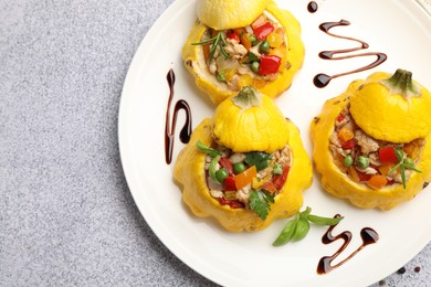 Photo of Tasty stuffed pattypan squashes on grey table, top view