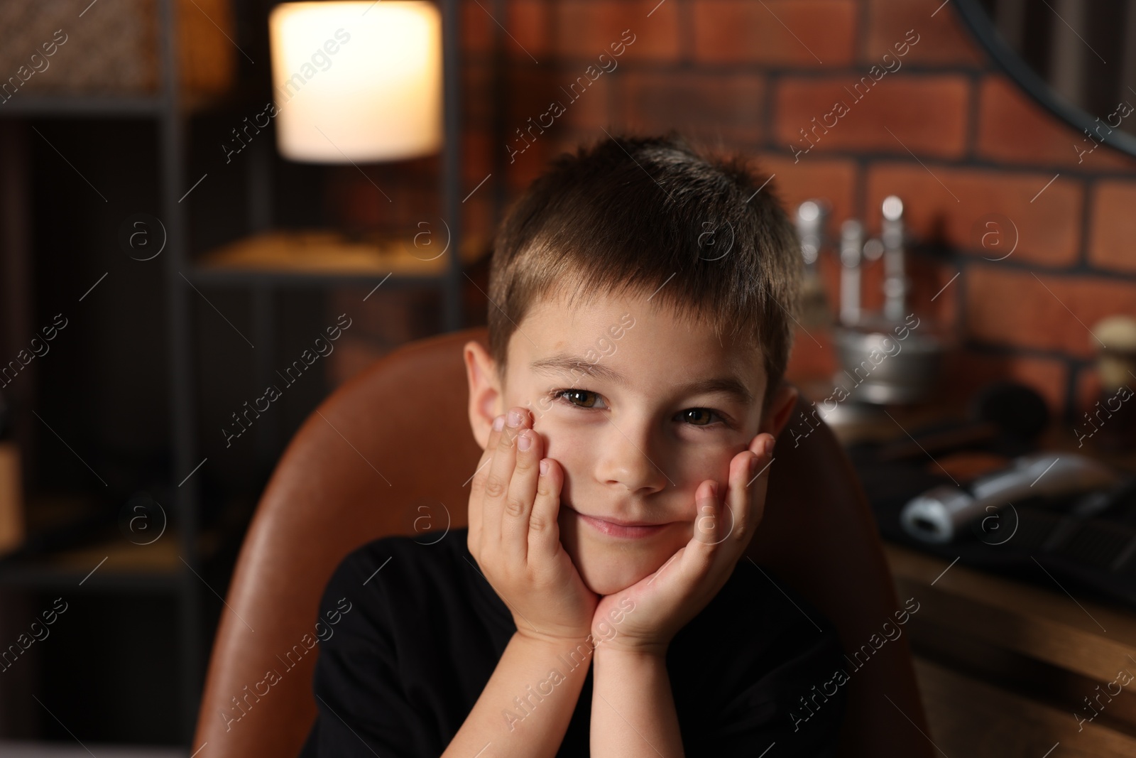 Portrait of cute little boy in barbershop Photo of Portrait of cute little boy in barbershop