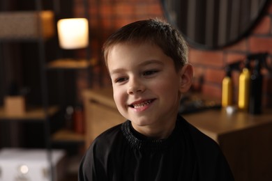Photo of Portrait of cute little boy in barbershop