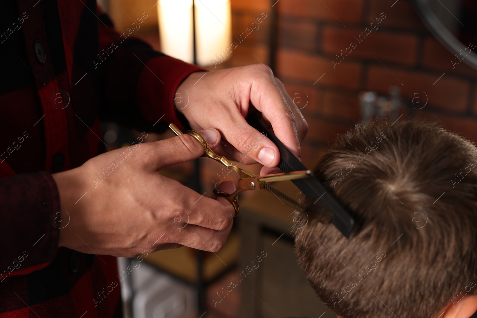 Professional barber cutting boy's hair in barbershop, closeup Photo of Professional barber cutting boy's hair in barbershop, closeup