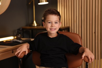 Photo of Portrait of cute little boy in barbershop