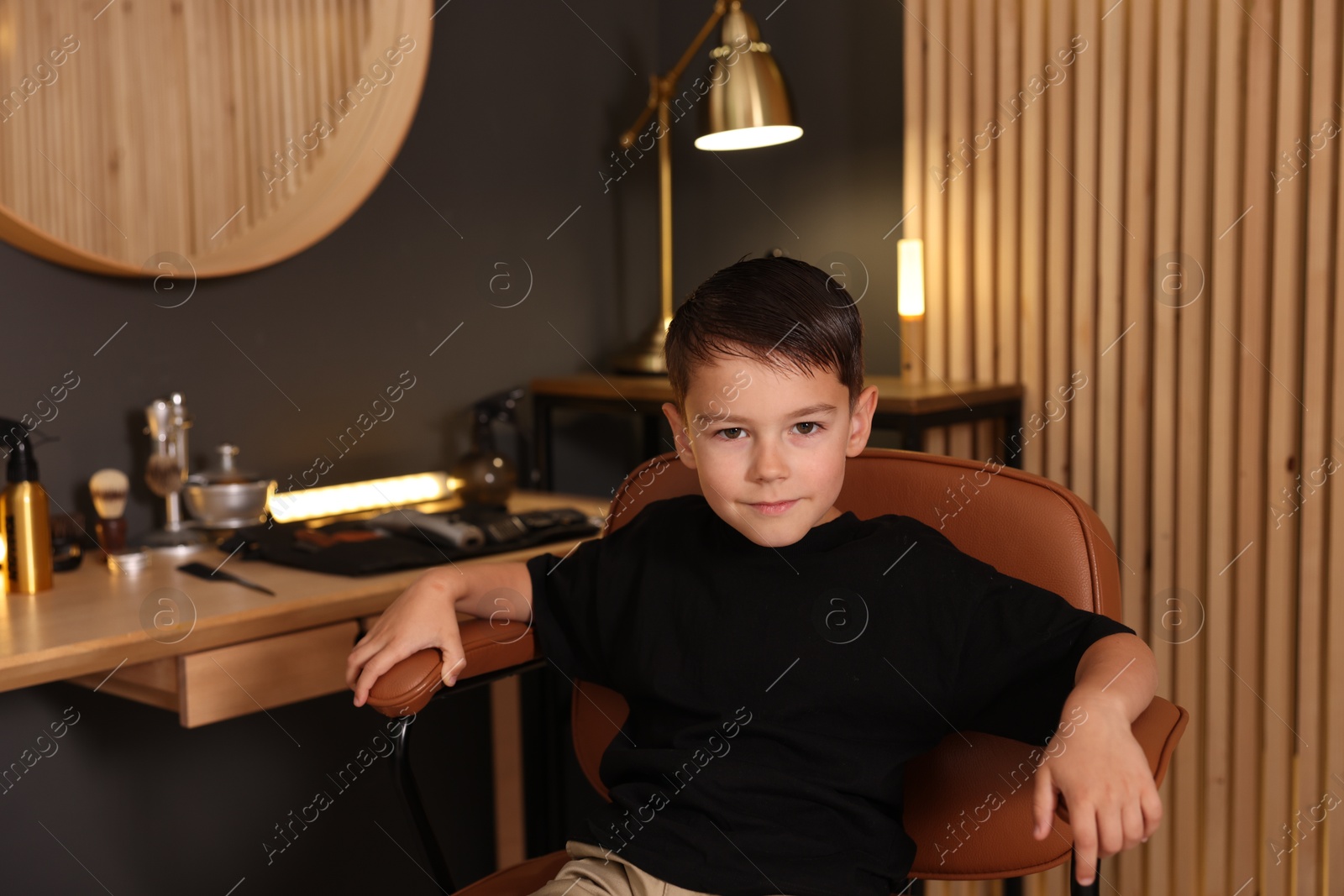 Cute little boy with wet hair in barbershop Photo of Cute little boy with wet hair in barbershop