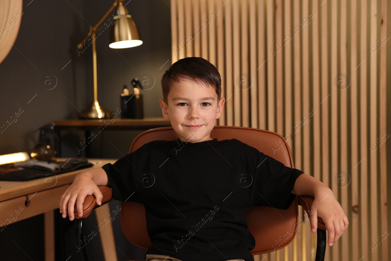 Cute little boy with wet hair in barbershop Photo of Cute little boy with wet hair in barbershop