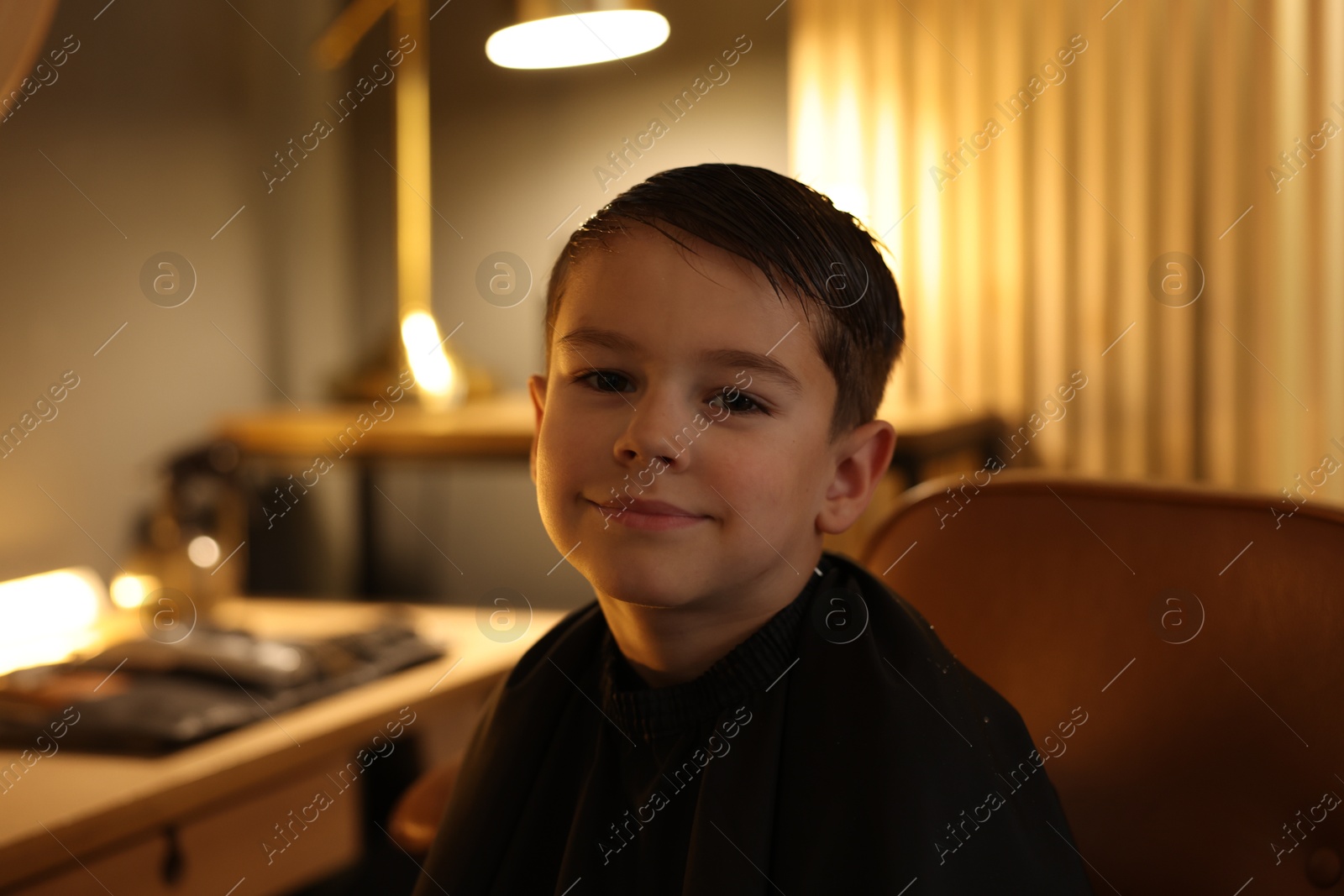 Portrait of cute little boy in barbershop Photo of Portrait of cute little boy in barbershop
