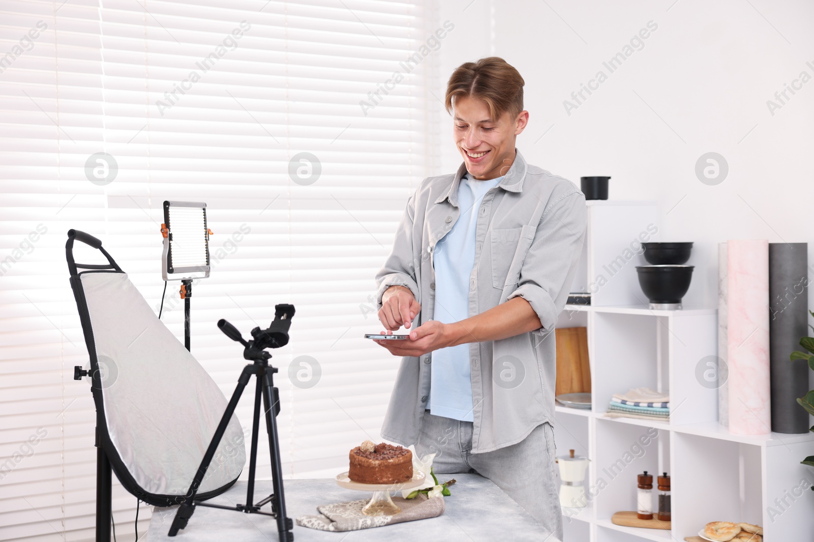 Man taking picture of chocolate cake in studio. Professional food photography Photo of Man taking picture of chocolate cake in studio. Professional food photography