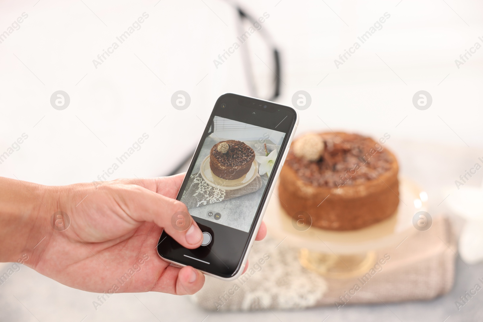 Man taking picture of chocolate cake in studio, selective focus. Professional food photography Photo of Man taking picture of chocolate cake in studio, selective focus. Professional food photography