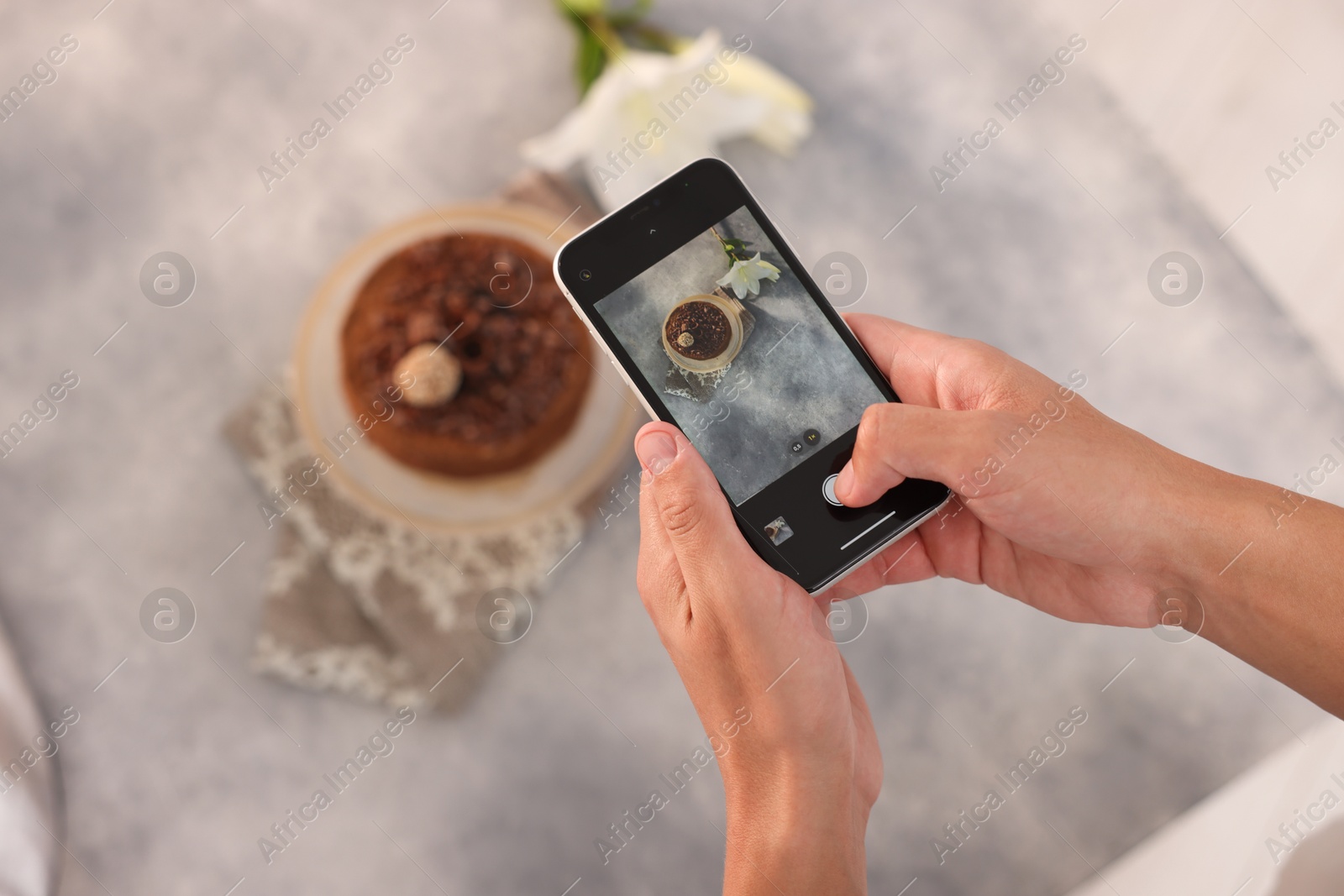 Man taking picture of chocolate cake in studio, top view. Professional food photography Photo of Man taking picture of chocolate cake in studio, top view. Professional food photography