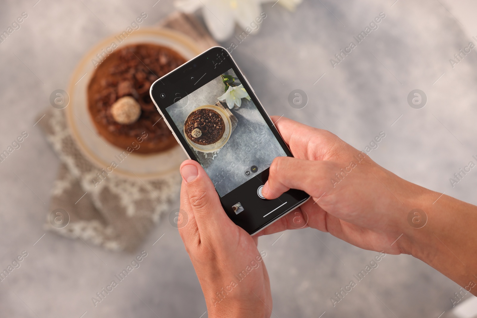Man taking picture of chocolate cake in studio, top view. Professional food photography Photo of Man taking picture of chocolate cake in studio, top view. Professional food photography