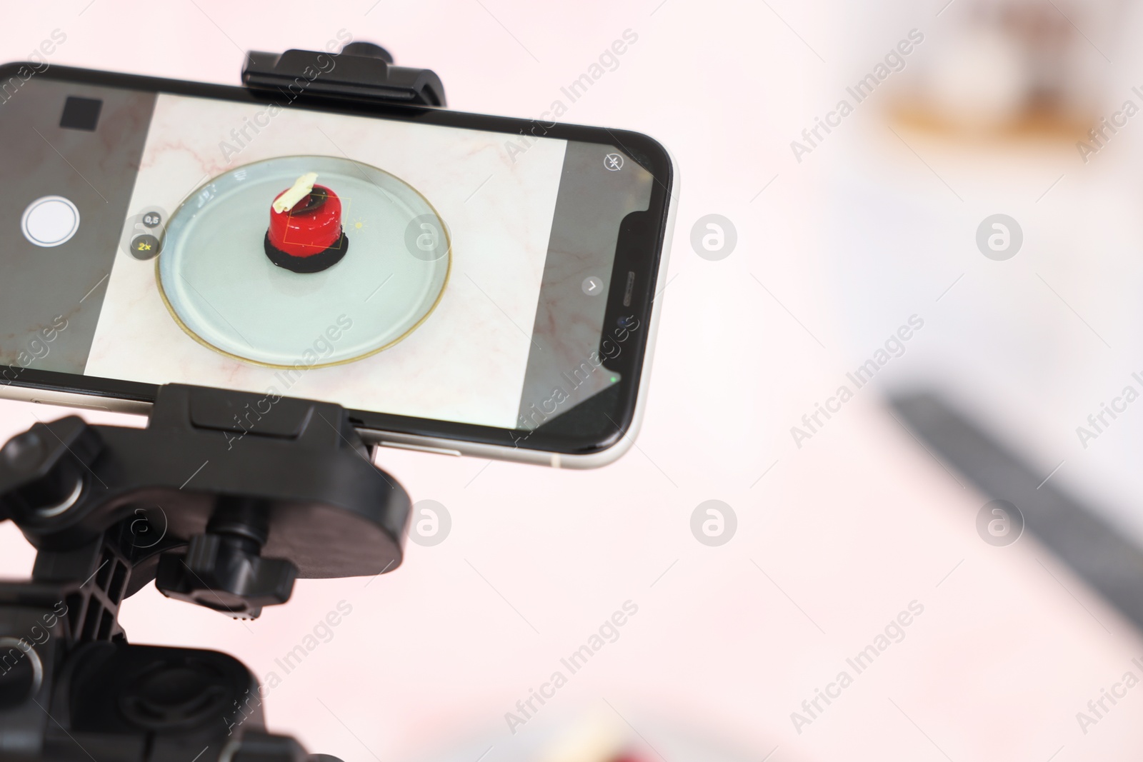 Photo of Shooting tasty dessert with smartphone in studio, selective focus. Professional food photography