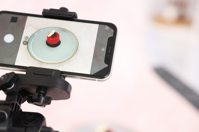 Photo of Shooting tasty dessert with smartphone in studio, selective focus. Professional food photography