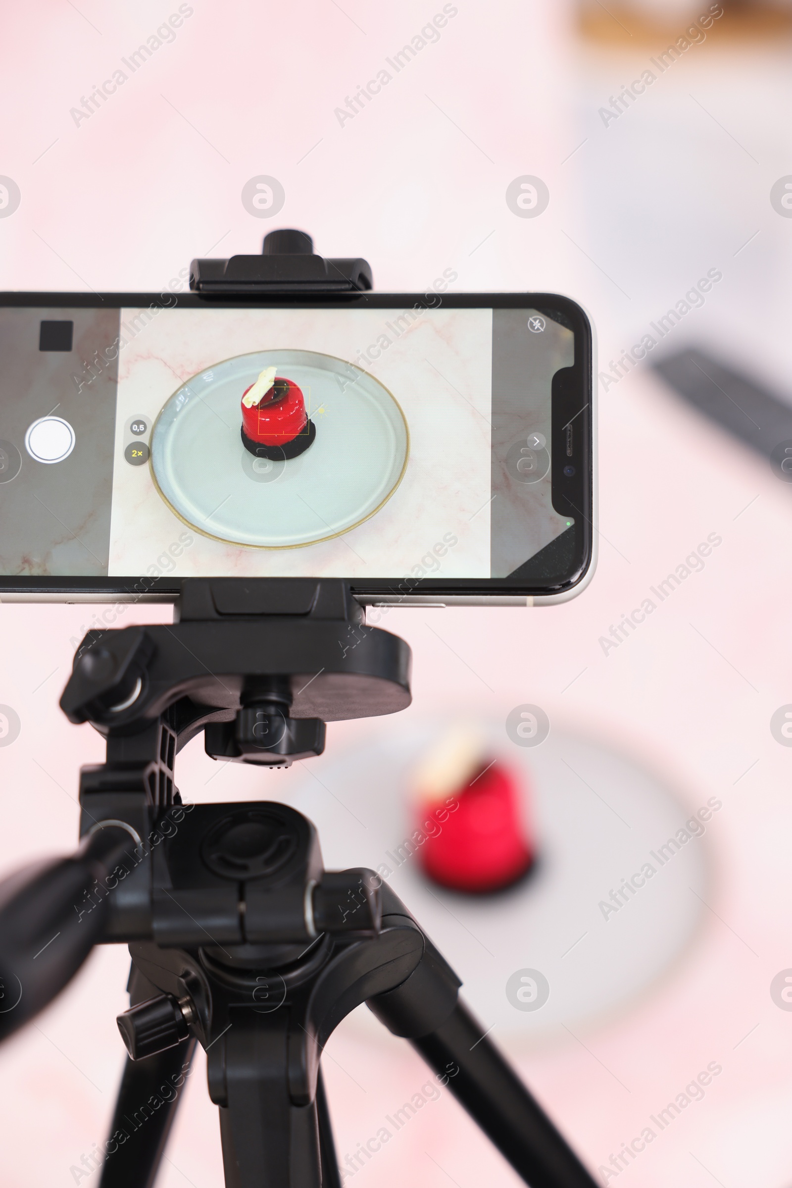 Photo of Shooting tasty dessert with smartphone in studio, selective focus. Professional food photography
