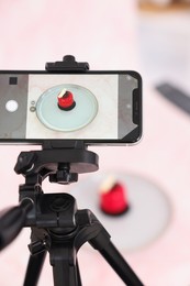 Photo of Shooting tasty dessert with smartphone in studio, selective focus. Professional food photography
