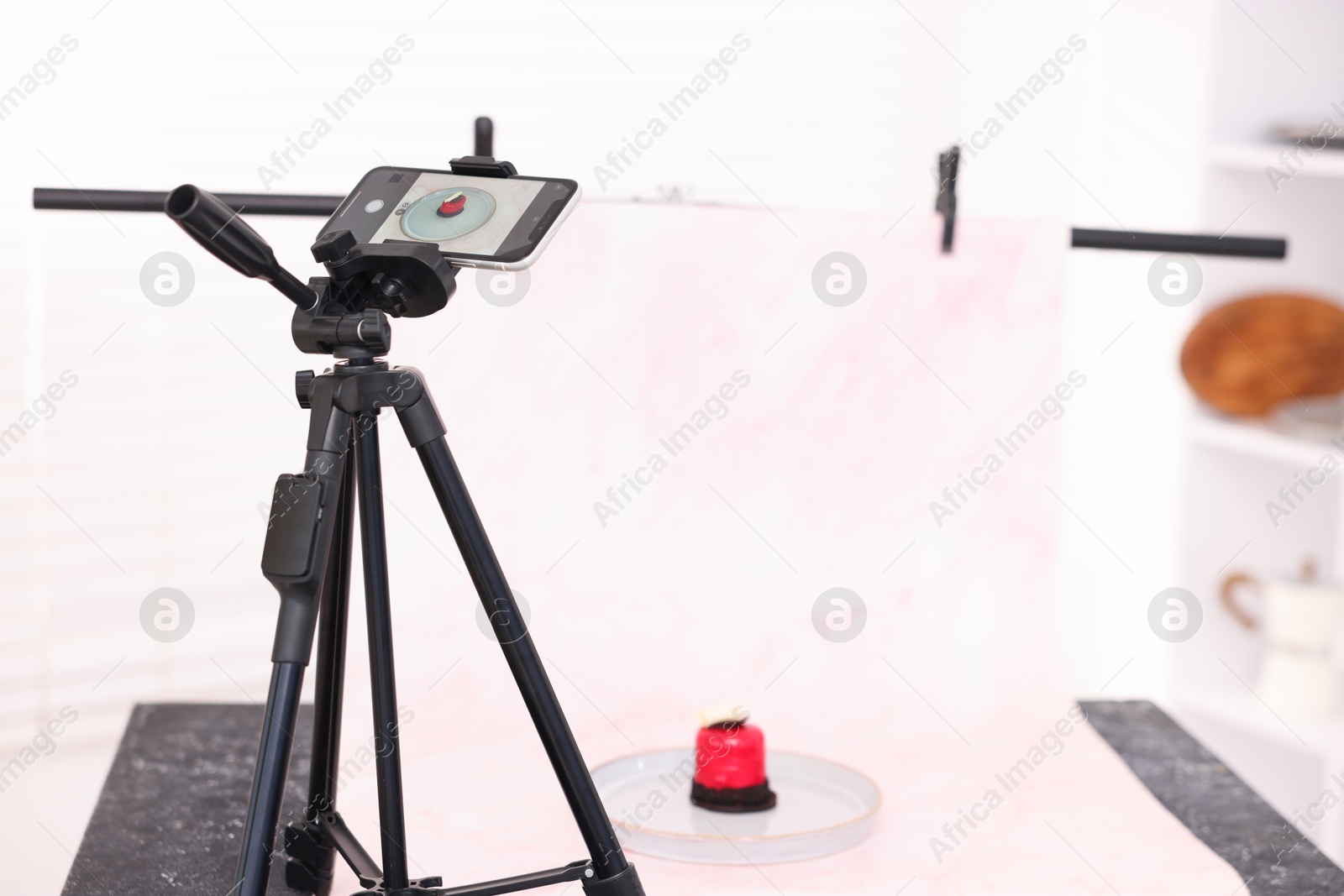 Photo of Shooting tasty dessert with smartphone in studio, selective focus. Professional food photography
