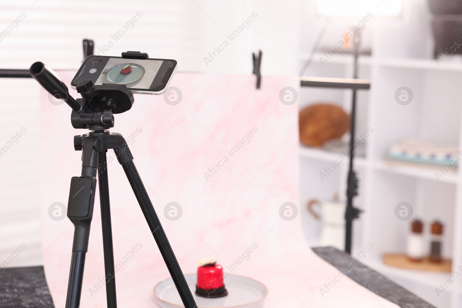 Photo of Shooting tasty dessert with smartphone in studio, selective focus. Professional food photography