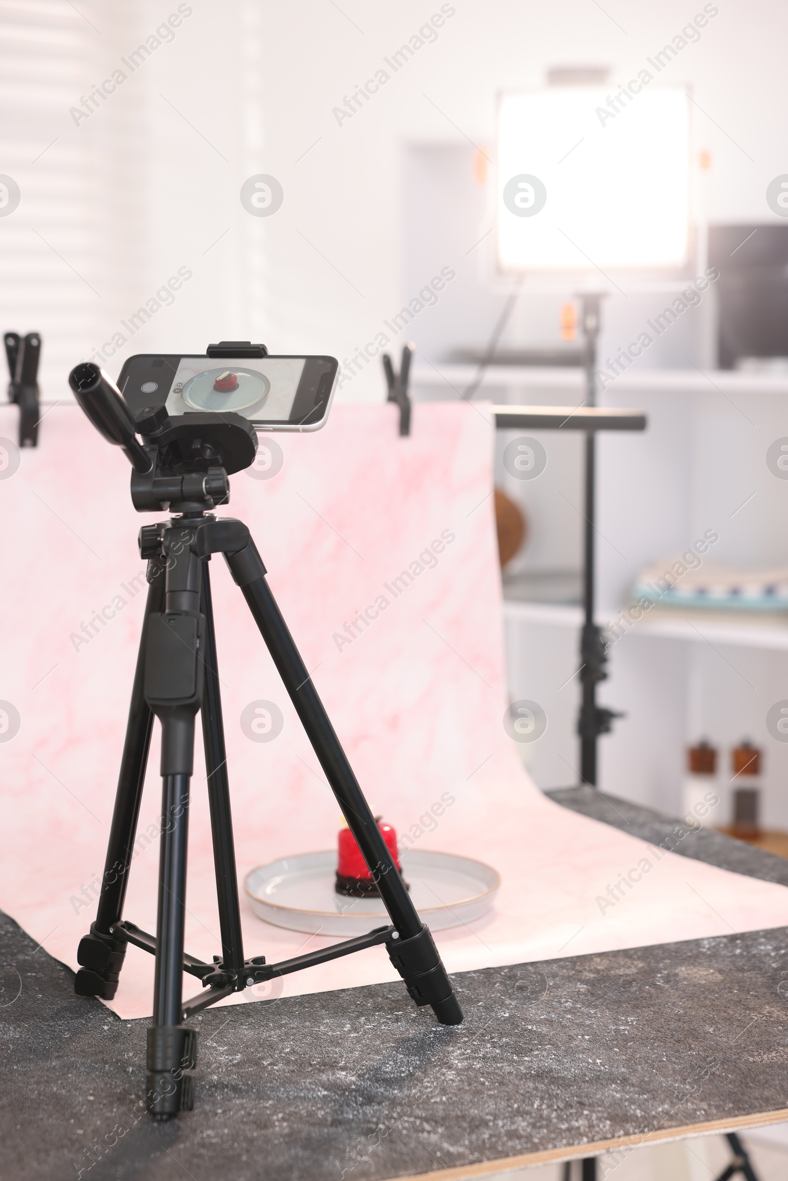 Photo of Shooting tasty dessert with smartphone in studio. Professional food photography