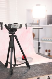 Photo of Shooting tasty dessert with smartphone in studio. Professional food photography