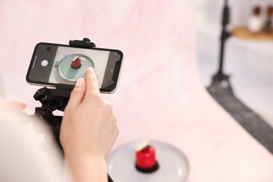 Photo of Woman taking picture of tasty dessert in studio, selective focus. Professional food photography