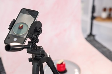 Photo of Shooting tasty dessert with smartphone in studio, selective focus. Professional food photography