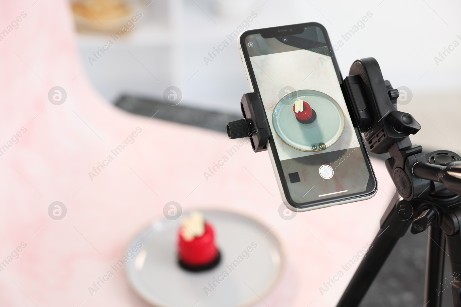 Photo of Shooting tasty dessert with smartphone in studio, selective focus. Professional food photography