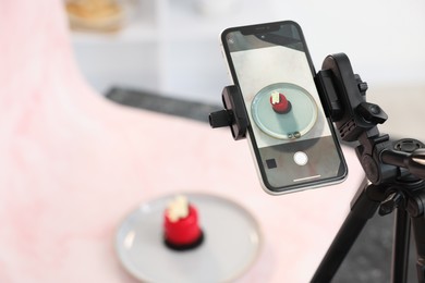 Photo of Shooting tasty dessert with smartphone in studio, selective focus. Professional food photography