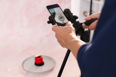 Photo of Man taking picture of tasty dessert in studio, selective focus. Professional food photography