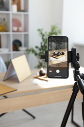 Photo of Shooting chocolate muffins with smartphone in studio, selective focus. Professional food photography
