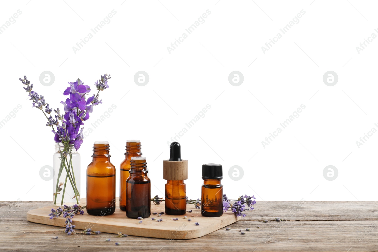 Photo of Bottles of essential oils and different plants on wooden table against white background