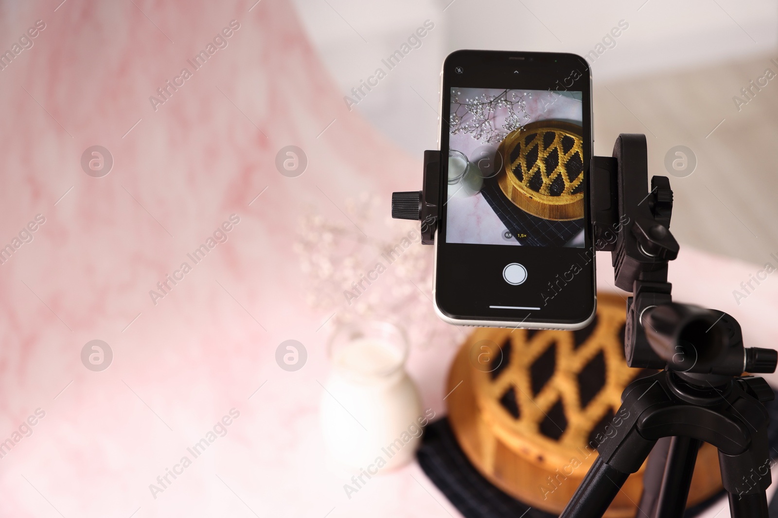 Photo of Shooting tasty pie and milk with smartphone in studio, above view. Professional food photography