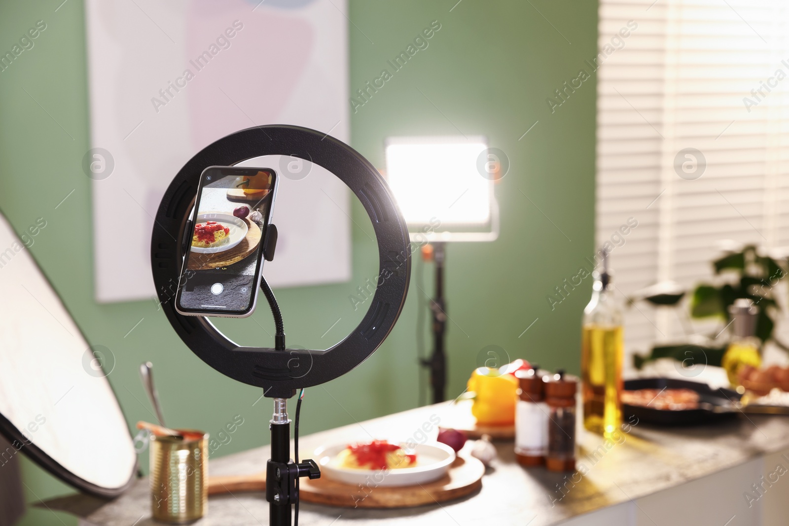 Photo of Shooting tasty pasta and ingredients with smartphone in studio, selective focus. Professional food photography