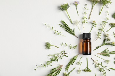 Photo of Essential oil and different plants on white background, flat lay. Space for text